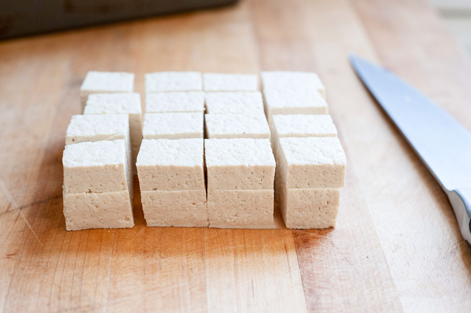 A block of tofu cut into cubes.